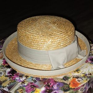 Stunning straw hat with khaki color trim and band